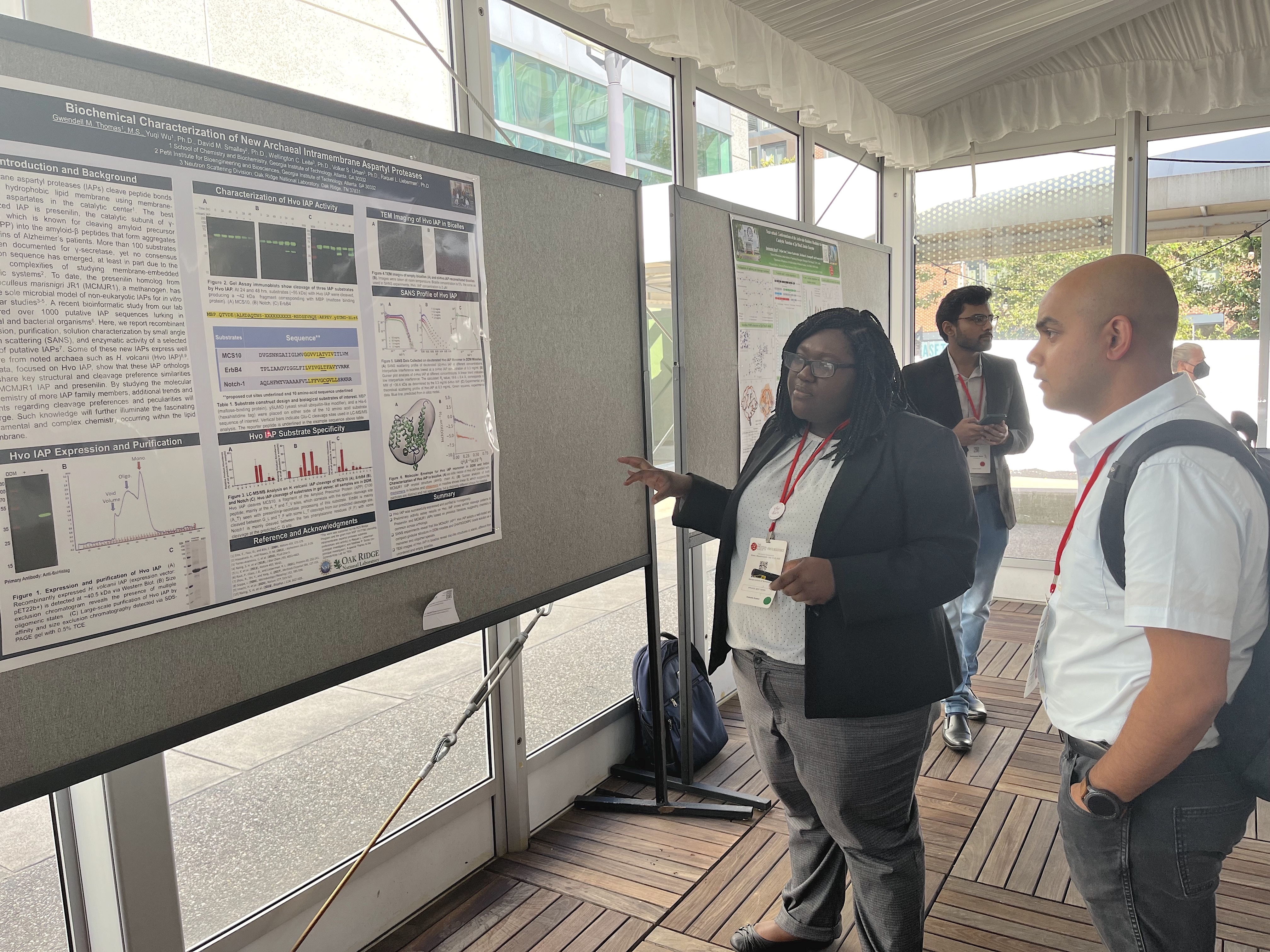 Gwen Thomas explains her research during a poster session at the Protein Society meeting in Boston in July. (Photo Raquel Lieberman).jpg