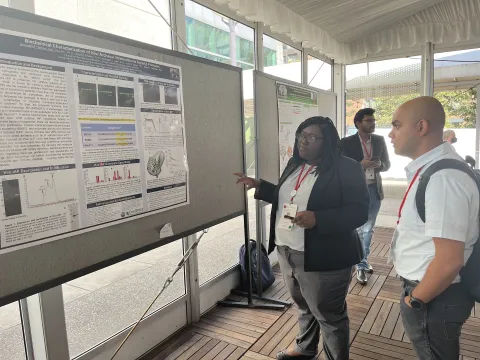 Gwen Thomas explains her research during a poster session at the Protein Society meeting in Boston in July. (Photo Raquel Lieberman).jpg
