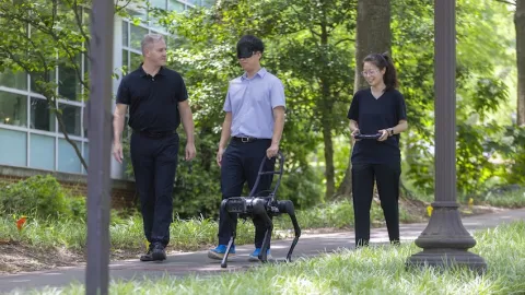 Georgia Tech researchers test their prototype of a robotic guide dog. Photo by Terence Rushin/College of Computing.