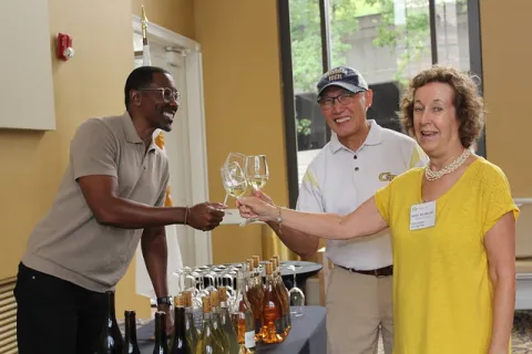 La Fête Wine Company Founder and CEO Donae Burston (Industrial Engineering 1998), Norman Chu (Electrical Engineering 1984), and Friends of Sciences Steering Committee Member Kathy Wilson-Chu raise a toast to Georgia Tech.