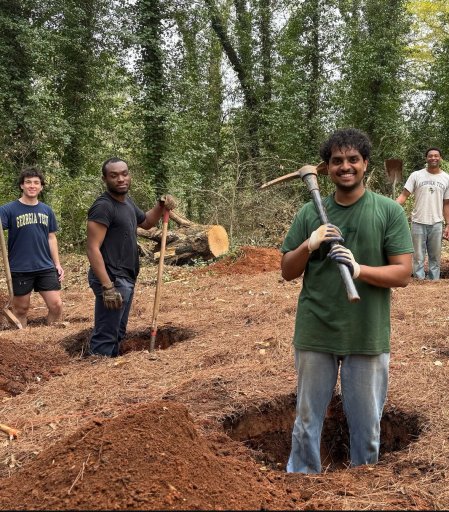 Benjamin Manoj (front) and other Yellow Jackets Against Poverty members dig holes for the foundation of a new homeless shelter.