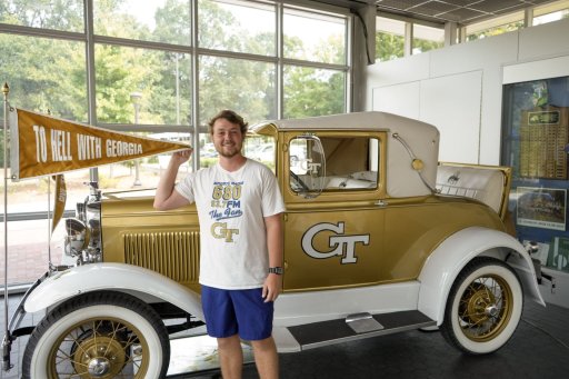 Josh Hembree, a mathematics major from Villa Rica, Georgia, poses with the Ramblin’ Wreck, Georgia Tech’s 1930 Ford Model A Sport Coupe mascot, of which he is the sole driver for 2025. 